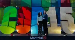 Anna Schutt and Lynn Heller in front of COP15 logo